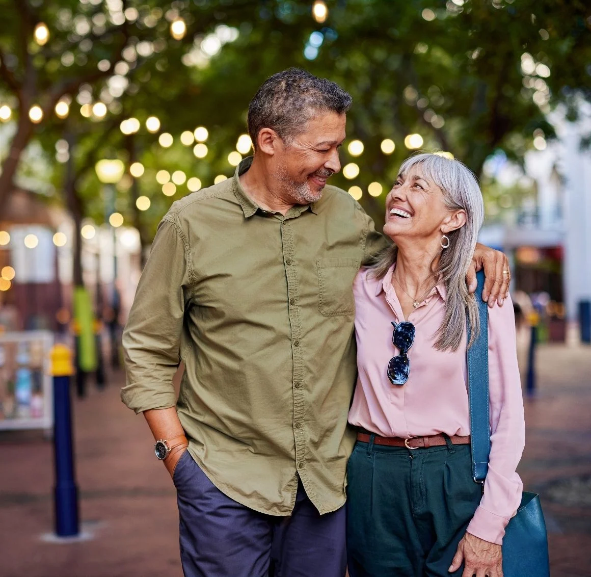mature-couple-laughing-walking-outdoors we provide senior home care in Carbondale