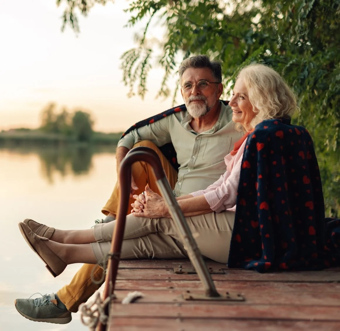 senior-couple-sitting-on-dock-by-lake senior home care in Pawnee