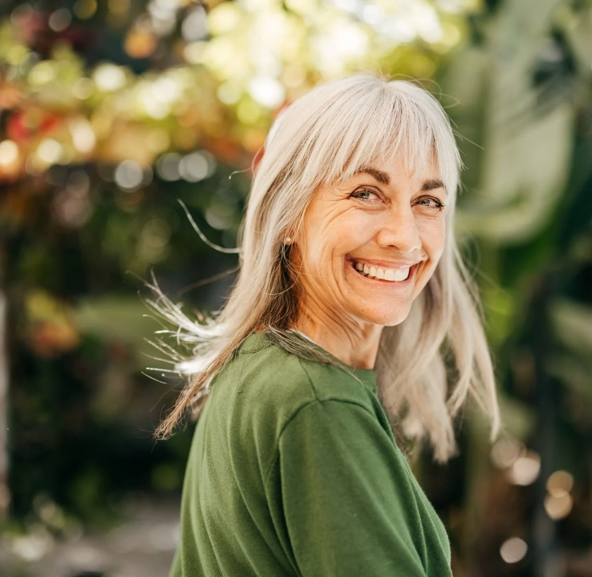 senior-woman-smiling-outdoors-in-garden