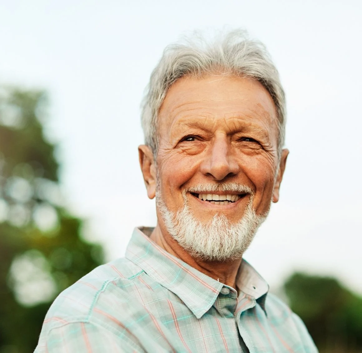 senior-man-with-beard-smiling-portrait-outdoors